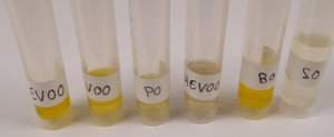Sample vials labelled with different types of olive oil for analysis